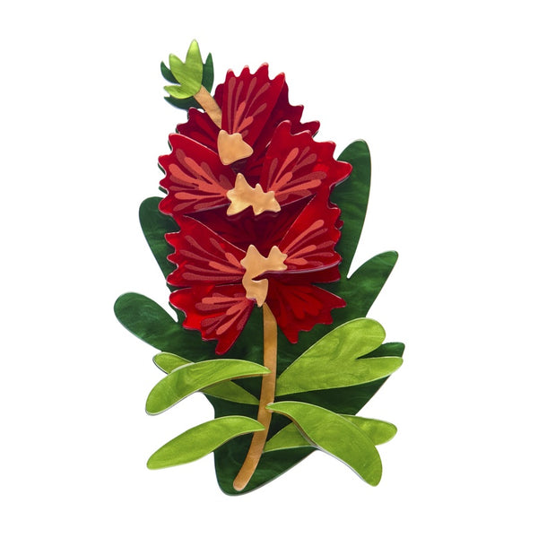 Red bottle brush resin brooch design with green leaves on a white background
