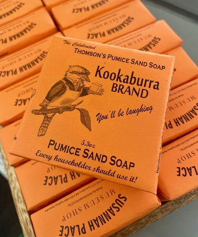 Kookaburra Brand Pumice Sand Soap packaging with a Kookaburra illustration on an orange background.