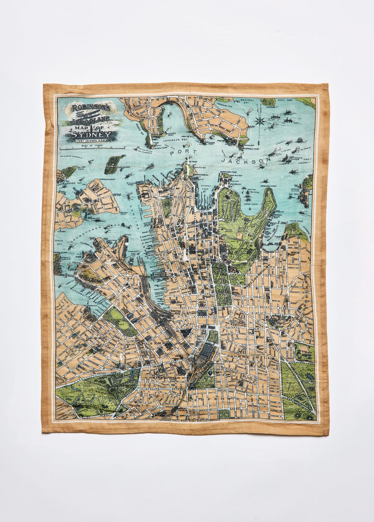A linen and cotton tea towel with a vintage map of Sydney printed on it, featuring various streets and landmarks.