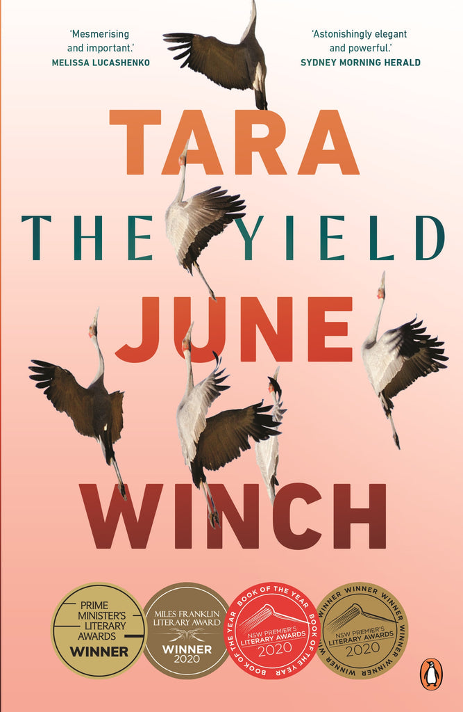 The cover of the book 'The Yield' by Tara June Winch features a flock of birds in flight against a pink and orange background, with the author's name at the top.