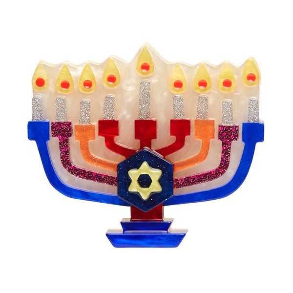 Erstwilder Holiday Lamp Brooch featuring a menorah in blue, pink, orange and red with silver glittery candles and a Star of David in the centre.