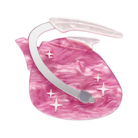 An Erstwilder pink resin brooch designed to look like a vintage 1950s atomic tea kettle with silver-plated steel clasps and decorative sparkles.