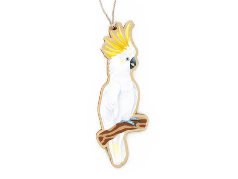 A wooden ornament in the shape of a Sulphur-crested Cockatoo, with a printed original painting printed on one side.