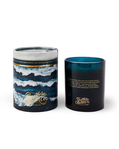 A dark blue glass candle with a poem printed on it, alongside a recyclable kraft paper tube packaging.