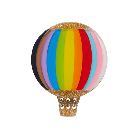 A colorful hot air balloon-shaped brooch featuring the Progressive Pride flag colours, with a gold glitter resin basket, featuring layers of multicolored resin and a chain for attaching to clothing.