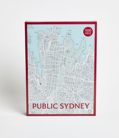 A 1000 piece jigsaw puzzle depicting a map of Sydney with a predominantly blue and white color scheme, packaged in a box with the puzzle name and cityscape graphic displayed.