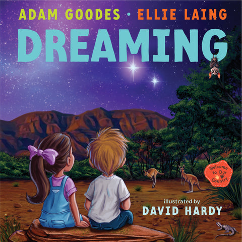 Cover of the book 'Dreaming: Welcome to Our Country' featuring illustrations by David Hardy, with a girl and a boy sitting on a rock looking at the stars in a night sky, with kangaroos and Uluru in the background.