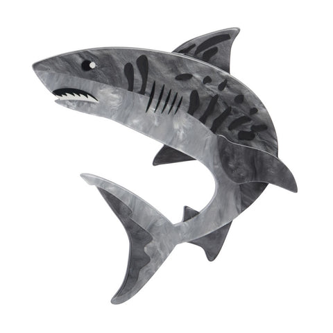 An Erstwilder layered resin brooch depicting a grey tiger shark with a textured pattern on its body.
