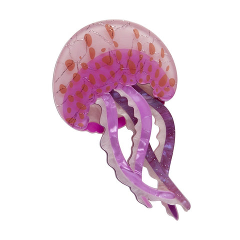 A purple and pink resin Erstwilder jellyfish brooch with layered resin and a pattern of smaller orange shapes on the surface.