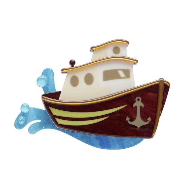 A resin brooch depicting a stylized boat with a timber and white color scheme and gold accents, with an anchor symbol on the front.