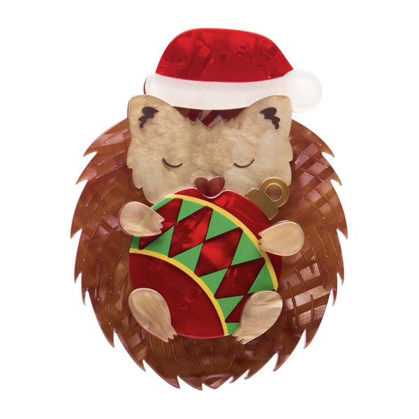 Erstwilder Hannah the Hedgehog layered resin brooch features a brown hedgehog hugging a Christmas bauble whilst wearing a Santa hat.