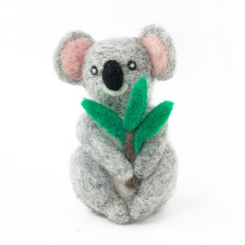 Wool felt koala holding a leaf on a white background