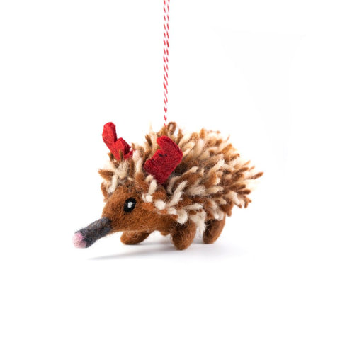 Felted wool Echidna Christmas ornament with red antlers on a white background