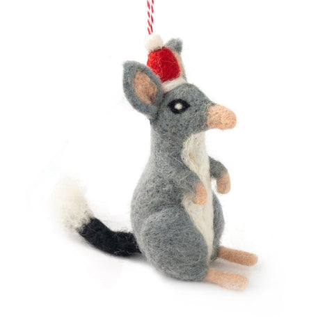A felted bilby Christmas ornament wearing a Santa hat, hanging from a red and white string against a white background.