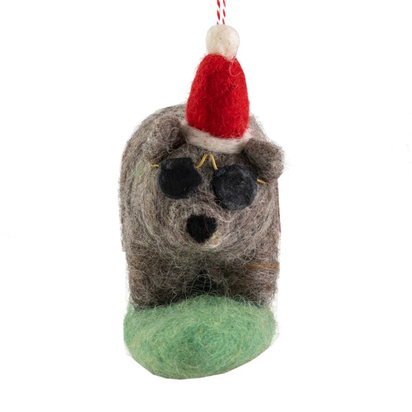 Decorative wombat ornament with a Santa hat, sunglasses riding a green surfboard hanging from a red-and-white string on a white background