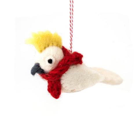 Decorative cockatoo Christmas ornament with a red scarf on a white background