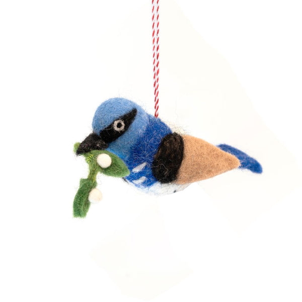 Felted bluebird ornament with mistletoe on a white background