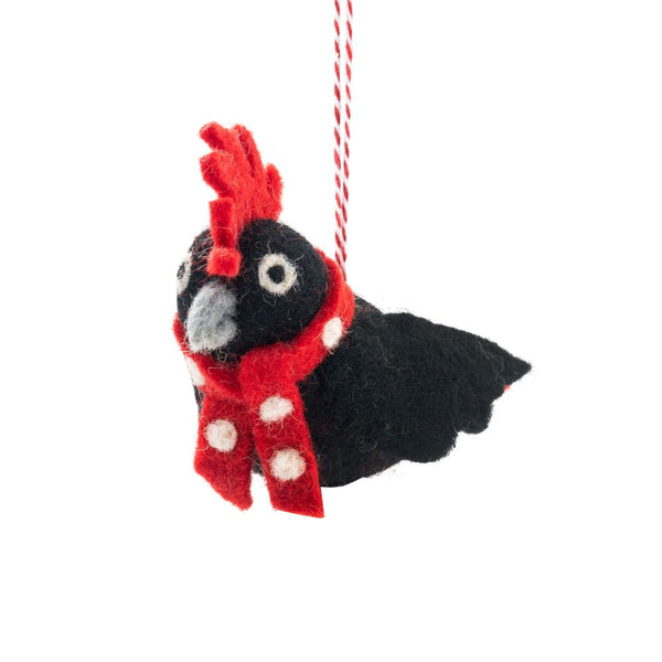 Decorative bird ornament with a red scarf on a white background