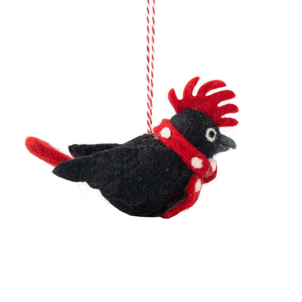 Decorative bird ornament with a red scarf on a white background