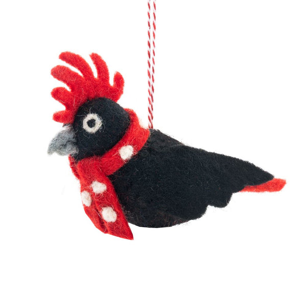 Decorative bird ornament with a red scarf on a white background