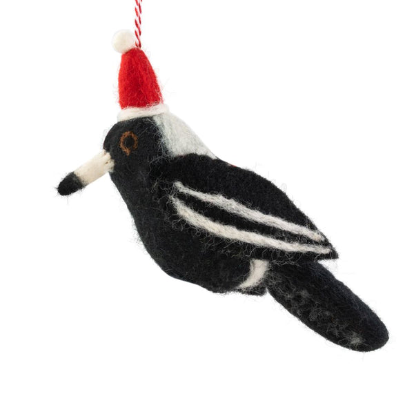 Felted bird ornament with a Santa hat on a white background