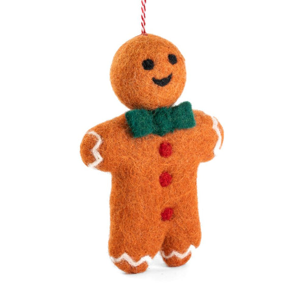 A felt gingerbread man ornament, with a green felt bow tie, red felt buttons, white felt trim, hanging from a red-and-white string, shown on a plain white background.