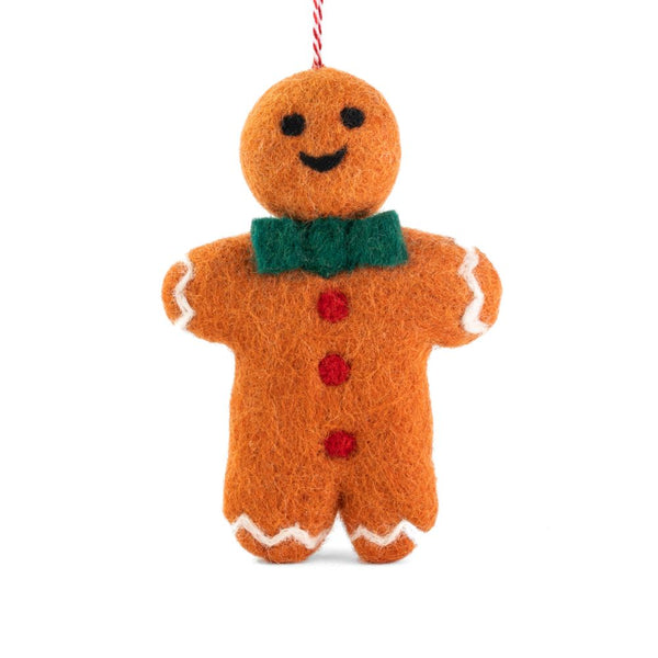 A felt gingerbread man ornament, with a green felt bow tie, red felt buttons, white felt trim, hanging from a red-and-white string, shown on a plain white background.