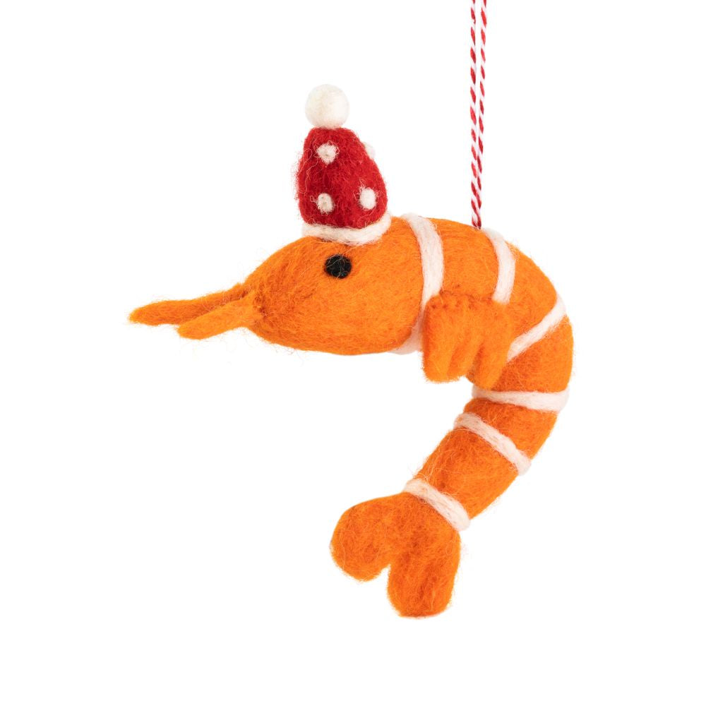 An orange felt prawn ornament wearing a Santa hat, hanging  by a red-and-white string, shown on a plain white background.