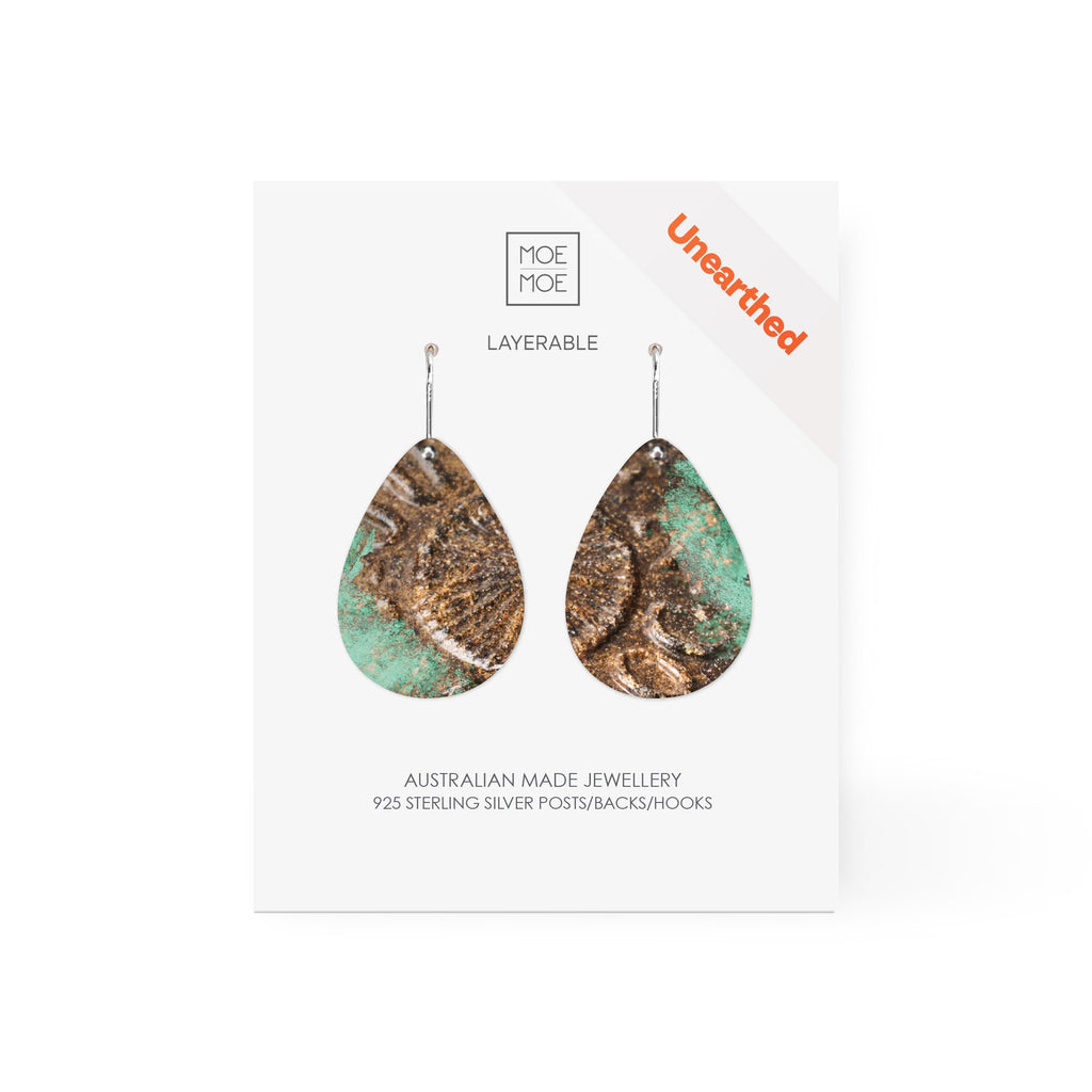 A pair of tear drop earrings featuring a pattern created from a digital image from the archaeology collection at Museum of Sydney