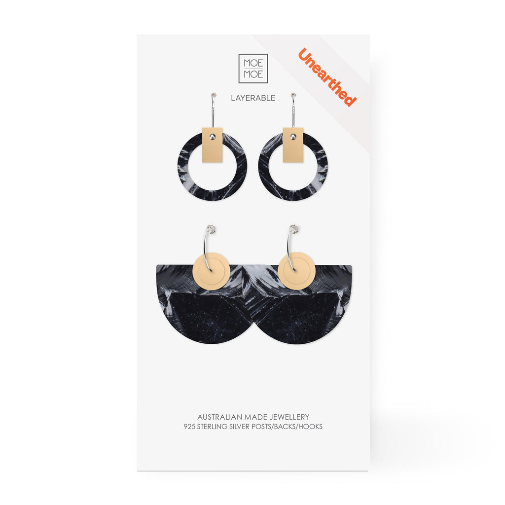 Two pairs of earrings featuring a black and white abstract pattern.