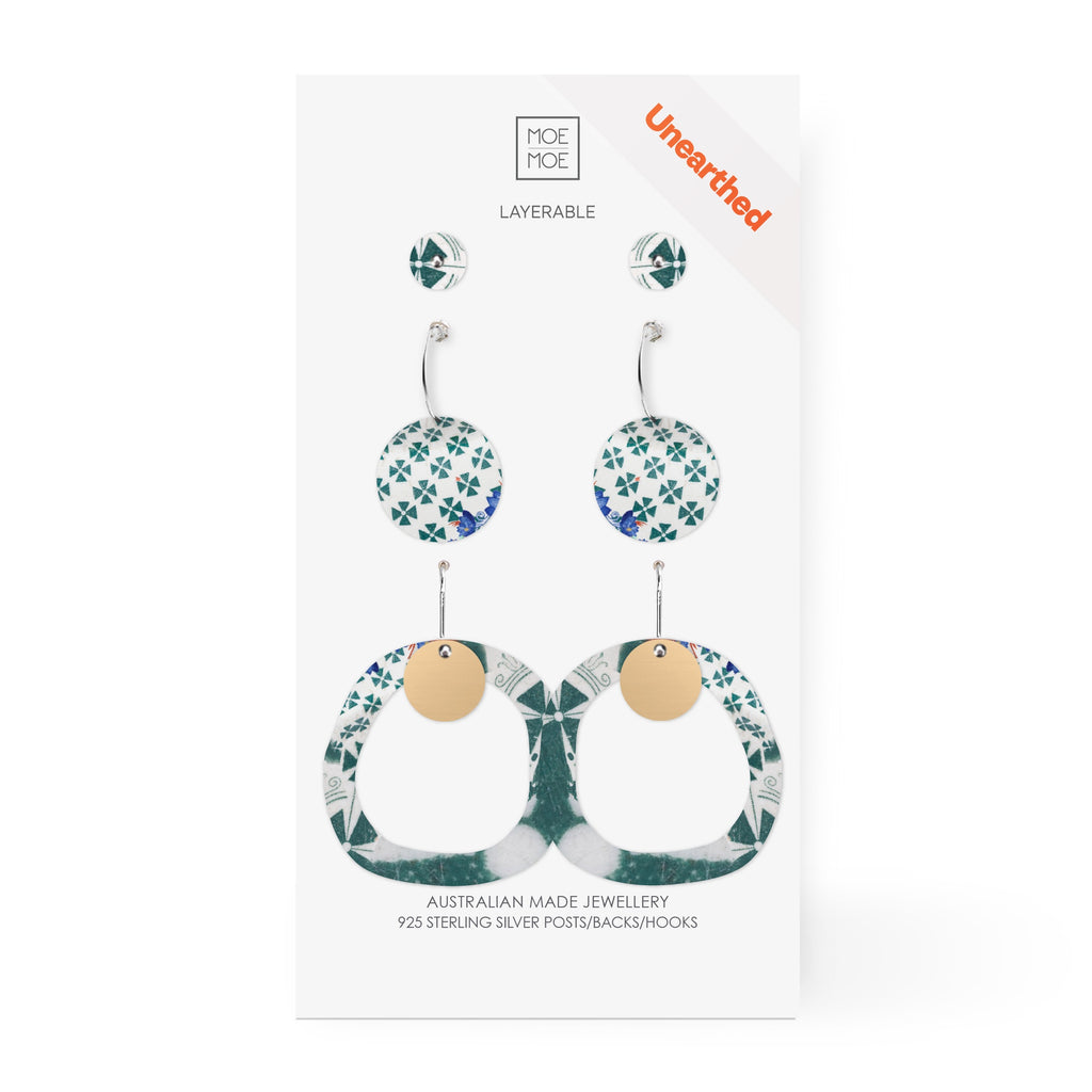 Three pairs of earrings featuring a green and white pattern