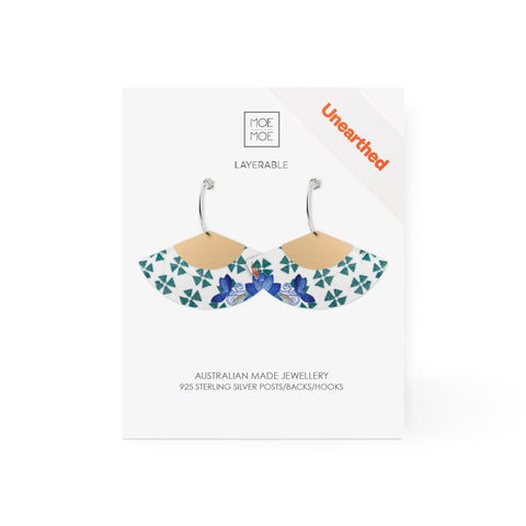 A pair of fan shaped earrings featuring a green and white pattern