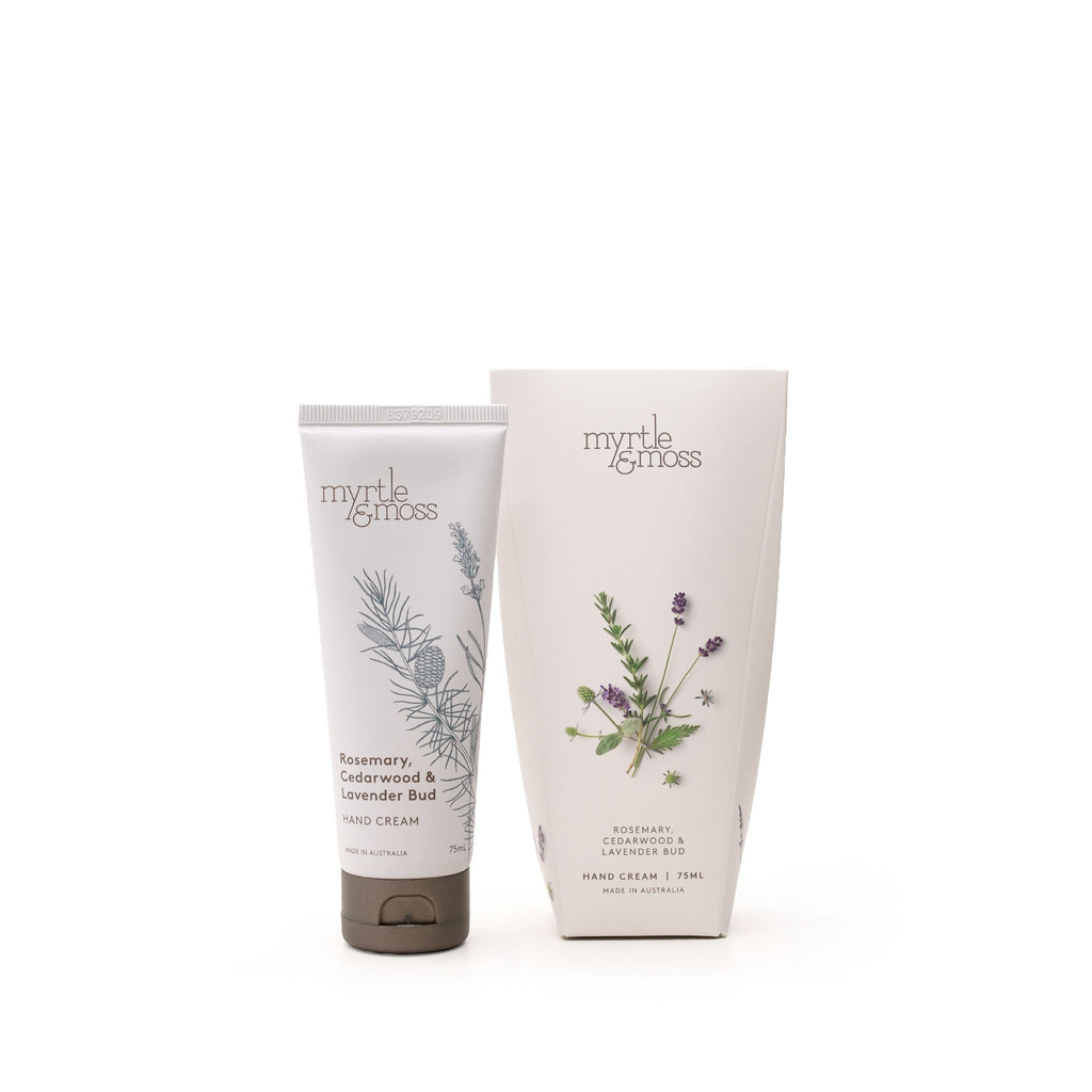 A tube of Myrtle & Moss hand cream next to its cardboard packaging.