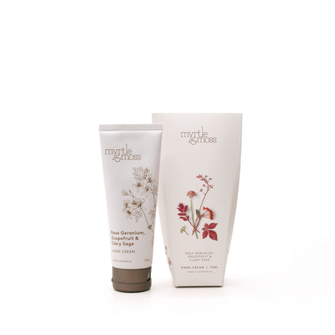 A tube of Myrtle & Moss hand cream next to packaging on a white background