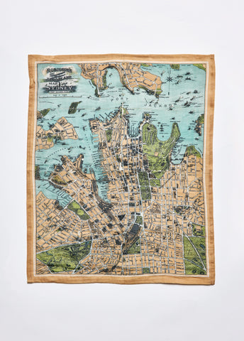 A linen and cotton tea towel with a vintage map of Sydney printed on it, featuring various streets and landmarks.
