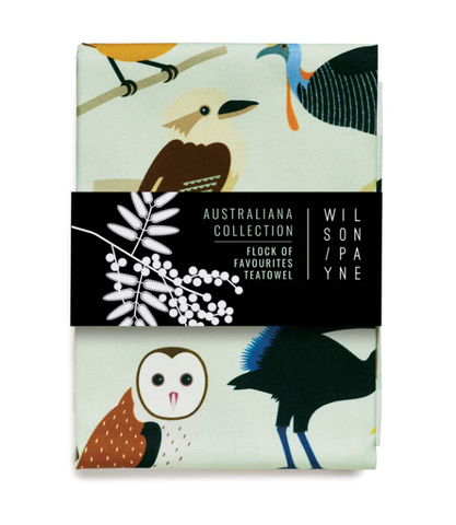 A folded multicolored tea towel featuring a pattern with various birds.