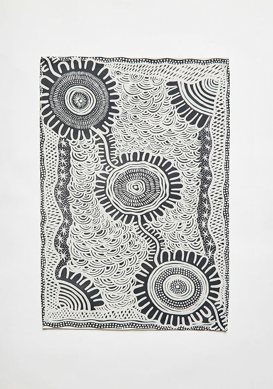 A black and white Indigenous artwork printed tea towel by Coomaditchie artist Allison Day.