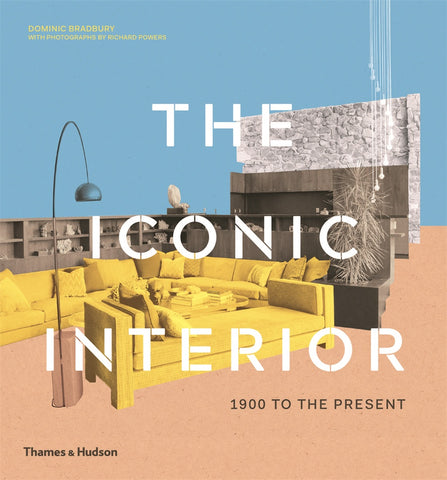 The cover of the book 'The Iconic Interior' featuring a photograph of a stylish interior design with a yellow sofa, a modern lamp, and a minimalist white wall.
