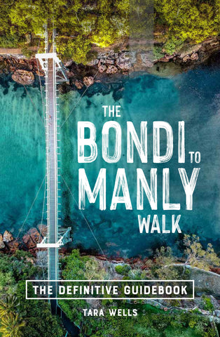 Cover of 'The Bondi to Manly Walk: The Definitive Guidebook' by Tara Wells, featuring an aerial image of the Parsley Bay bridge with greenery and blue water in the background.