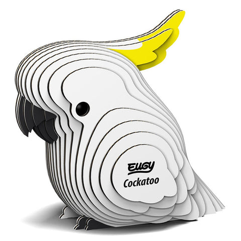 A 3D cardboard model kit of a cockatoo bird, with white and yellow colors, assembled from numbered pieces.