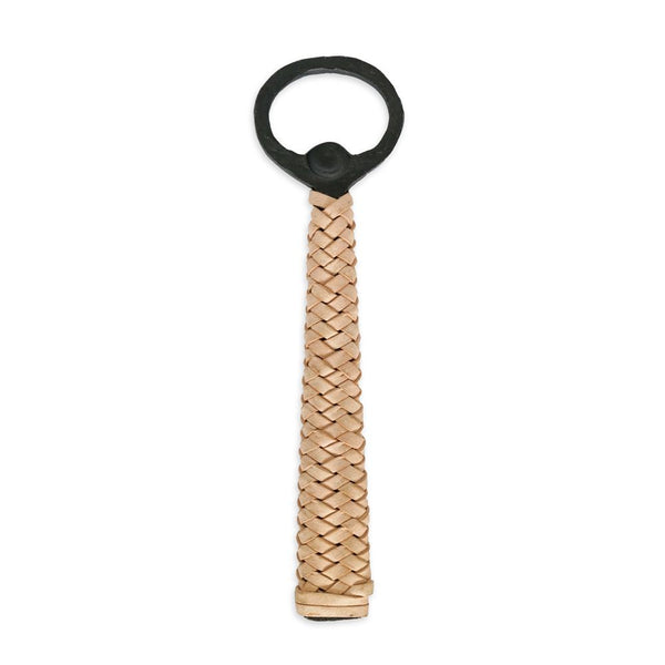 A bottle opener with a blackened iron handle and woven leather grip.