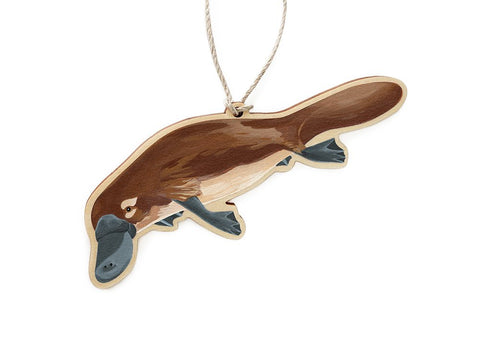 A wooden Christmas ornament in the shape of a platypus, with a printed original painting on one side.