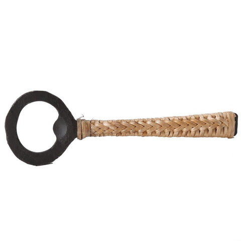 A blackened iron bottle opener with a woven cane finished handle.