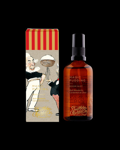 An amber glass bottle of Magic Pudding room mist with a spray nozzle, accompanied by its packaging box with illustrations.