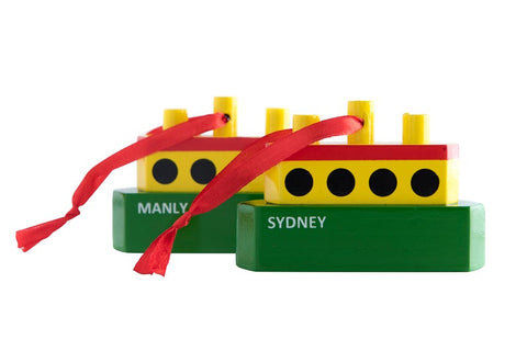 Two solid wood Christmas ornaments with 'SYDNEY' printed on them, one with a red ribbon and the other with a yellow ribbon, against a white background.