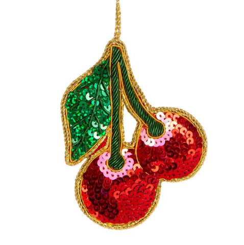 A sequined decoration in the shape of a cherry with a green leaf, red cherries, and a golden stem.