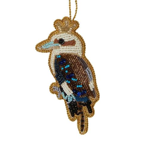 A sequin decoration in the shape of a kookaburra with   blue, and brown colors, featuring intricate detailing and a crown on the top.