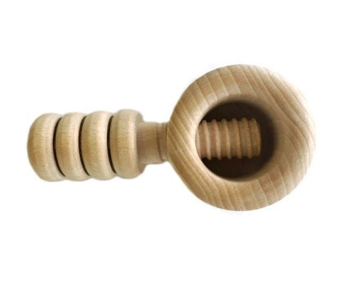 A wooden nutcracker with a round handle and a vice-like cracking mechanism.