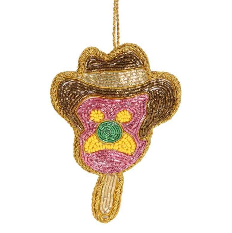 A beaded Christmas tree ornament resembling a Cowboy icecream, predominantly in brown, yellow and green with a golden trim.